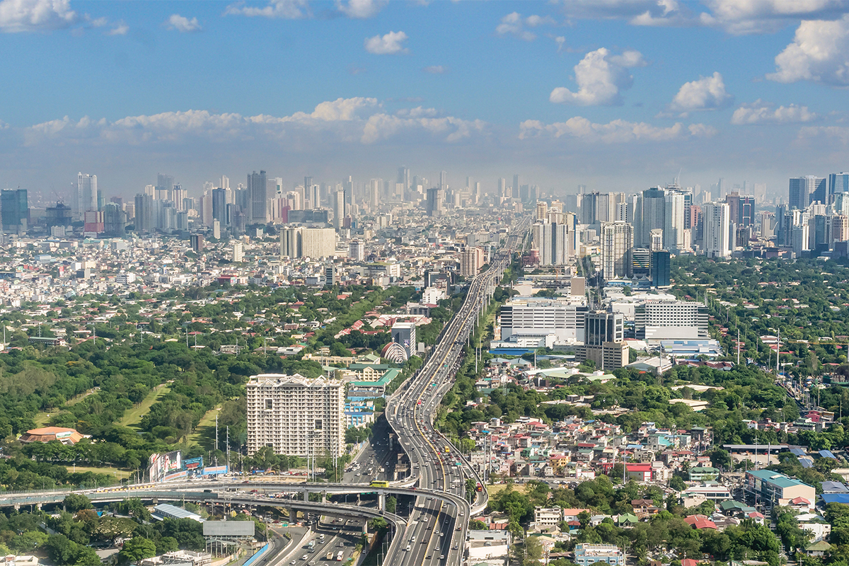 Metro Manila, Philippines - April 2022: The SLEX Skyway going towards the vast Metro Manila cityscape and skyline.