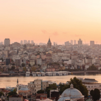 Amazing summer sunrise over turkish city and Bosphorus strait. Top view of tradition istanbul buildings. Heavy fog around during morning time.