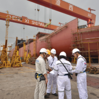 Crew members of the Light Venture compare notes at the Cheng Xi Shipyard in China’s Jiangsu province. | © WAH KWONG