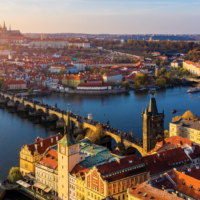 Aerial Prague panoramic drone view of the city of Prague at the Old Town Square, Czechia. Prague Old Town pier architecture and Charles Bridge over Vltava river in Prague at sunset, Czech Republic.