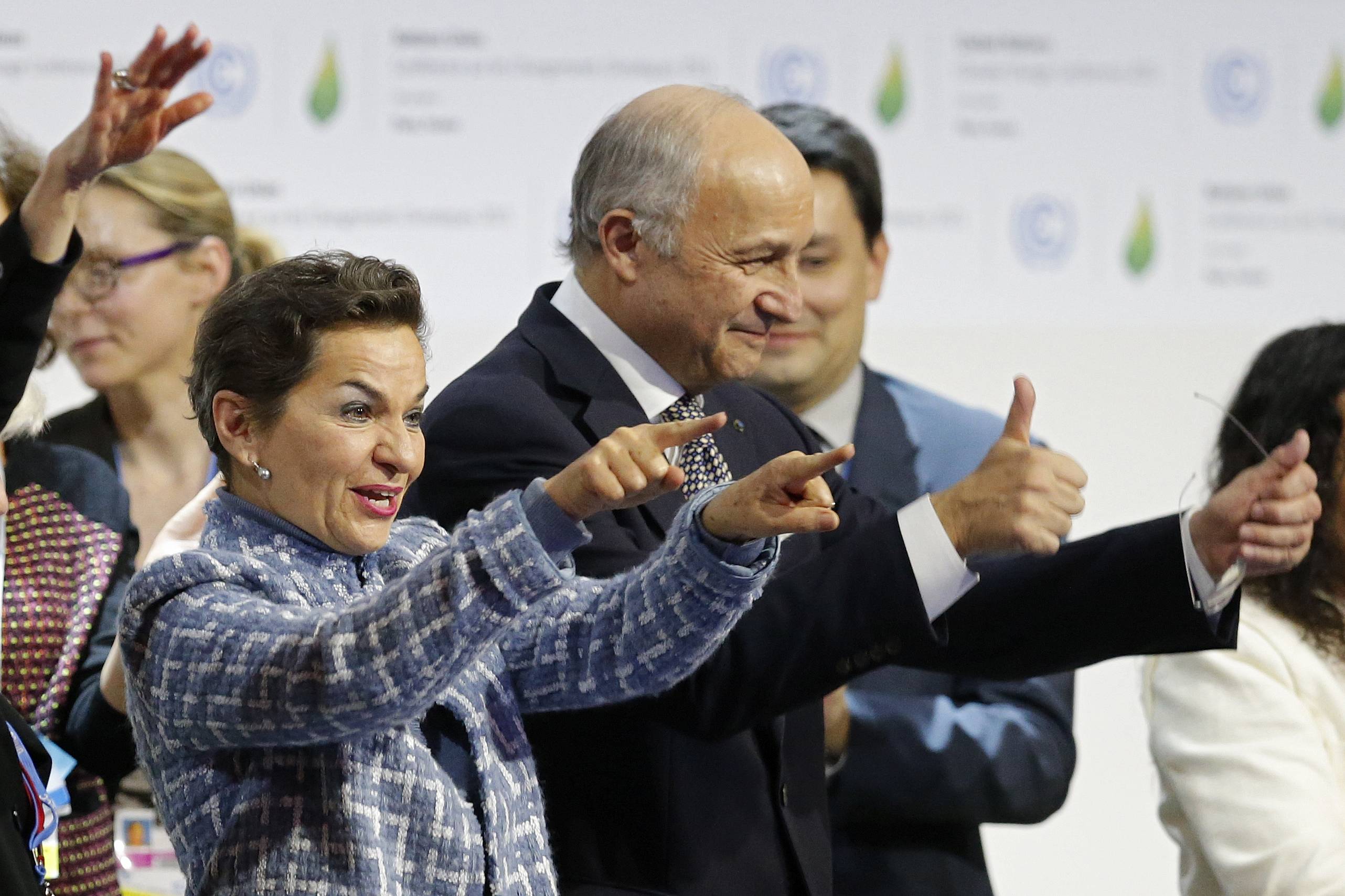 French Foreign Affairs Minister Laurent Fabius (right), president-designate of COP21, and Christiana Figueres, executive secretary of the U.N. Framework Convention on Climate Change, react during the final plenary session of the talks at Le Bourget, near Paris, on Dec. 12, 2015. | REUTERS