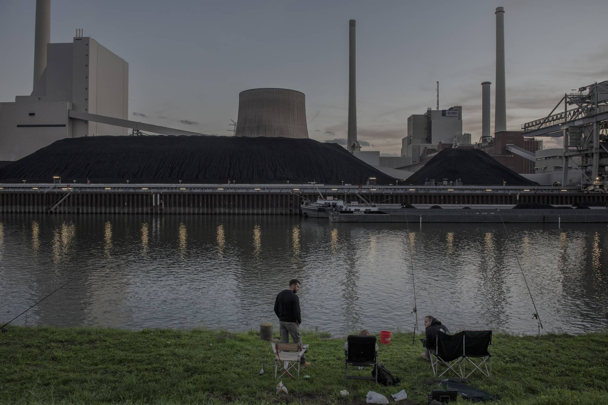 People gather in front of a power plant in Karlsruhe, Germany, on Oct. 26. The German government decided to cancel plans to shut some nuclear reactors, and to fire up coal power plants in hopes of making up for the loss of Russian gas.  | LAETITIA VANCON / THE NEW YORK TIMES