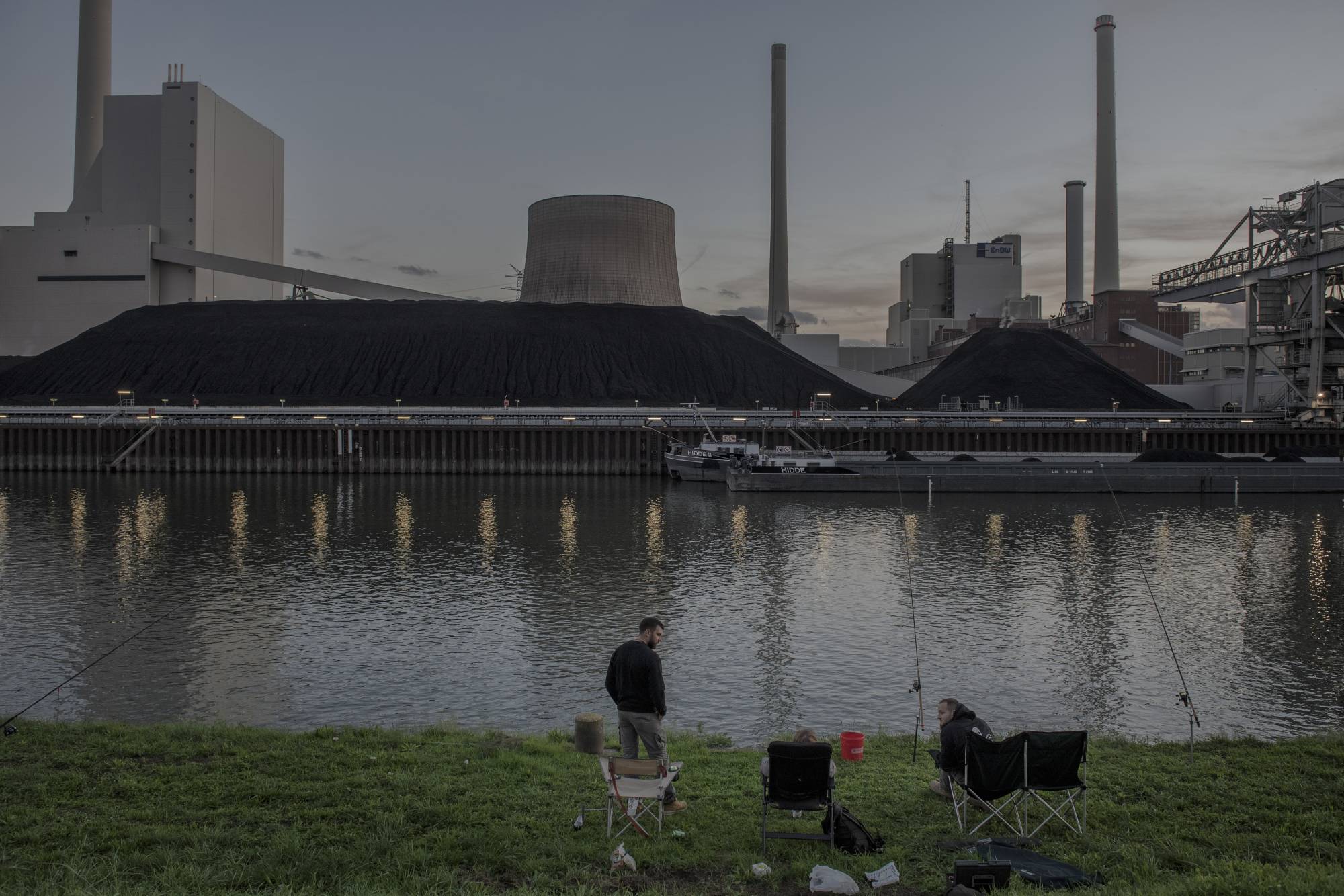 People gather in front of a power plant in Karlsruhe, Germany, on Oct. 26. The German government decided to cancel plans to shut some nuclear reactors, and to fire up coal power plants in hopes of making up for the loss of Russian gas. | LAETITIA VANCON / THE NEW YORK TIMES