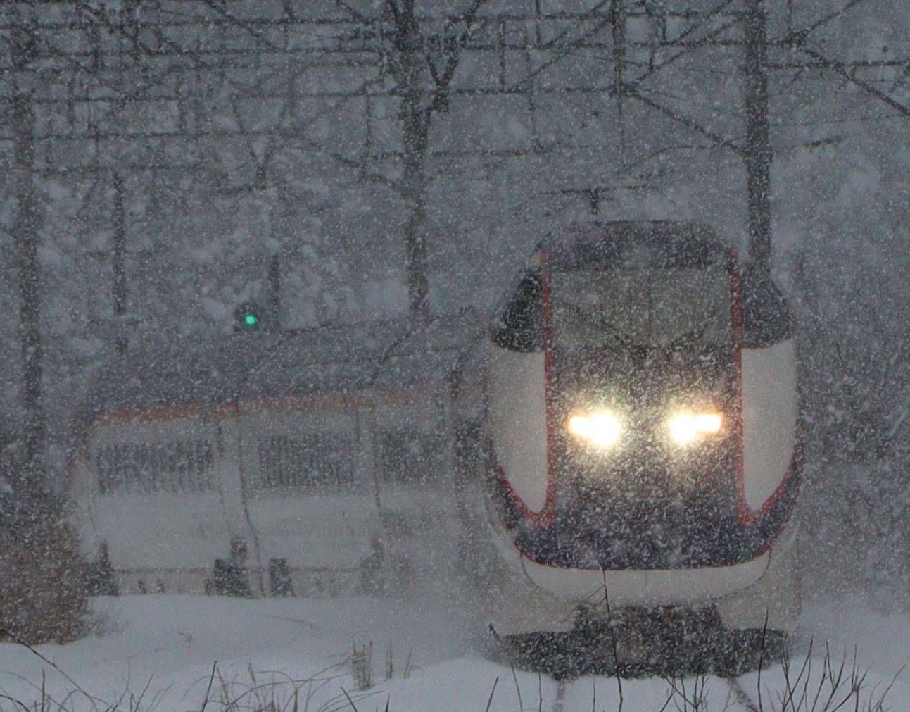 A Yamagata Shinkansen train passes through the Itaya Pass in Yonezawa, Yamagata Prefecture, amid heavy snow on Dec. 15. | KAHOKU SHIMPO