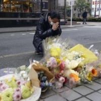A man prays for Miki Kawano, who was stabbed to death earlier this week, in Fukuoka on Thursday. | KYODO