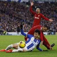Brighton\'s Kaoru Mitoma (bottom) in action with Liverpool\'s Joel Matip in Brighton on Saturday | REUTERS