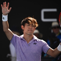 Japan\'s Yoshihito Nishioka celebrates Friday after beating American Mackenzie McDonald to reach the fourth round of the Australian Open.  | AFP-JIJI