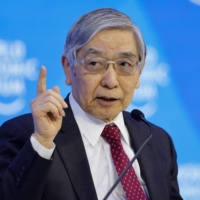 Bank of Japan Gov. Haruhiko Kuroda speaks during a panel session on the closing day of the World Economic Forum in Davos, Switzerland, on Friday. | BLOOMBERG