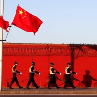 Chinese riot police patrol the perimeter of Beijing’s Capital International Airport in October 2020. | REUTERS