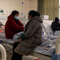Patients with COVID-19 rest at a hospital in Fengyang, China, on Jan. 5.  | AFP-JIJI