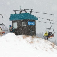 Skiers disembark a chairlift at Hachi Kogen Ski Resort. Energy costs are squeezing many of Japan’s smaller ski resorts. | BLOOMBERG