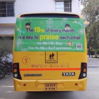 A school bus in India sports an ad on the back urging people to praise each other every month. | SPIRAL UP CO.
