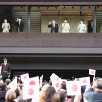 Emperor Naruhito (fourth from left), accompanied by Empress Masako and Princess Aiko, waves to well-wishers at the Imperial Palace in Tokyo on Jan. 2 as Crown Prince Fumihito (third from left) waves with Crown Princess Kiko and second daughter Princess Kako (left). | KYODO