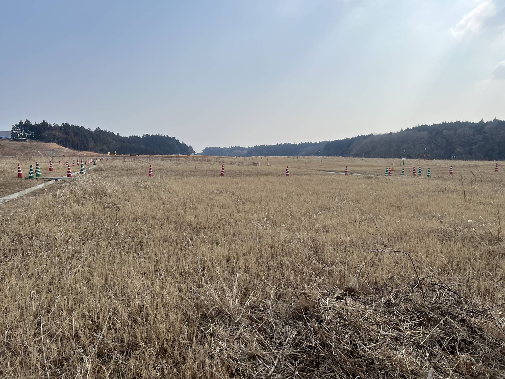 Areas where radioactive soil has been buried look like soccer fields. | TOMOKO OTAKE 