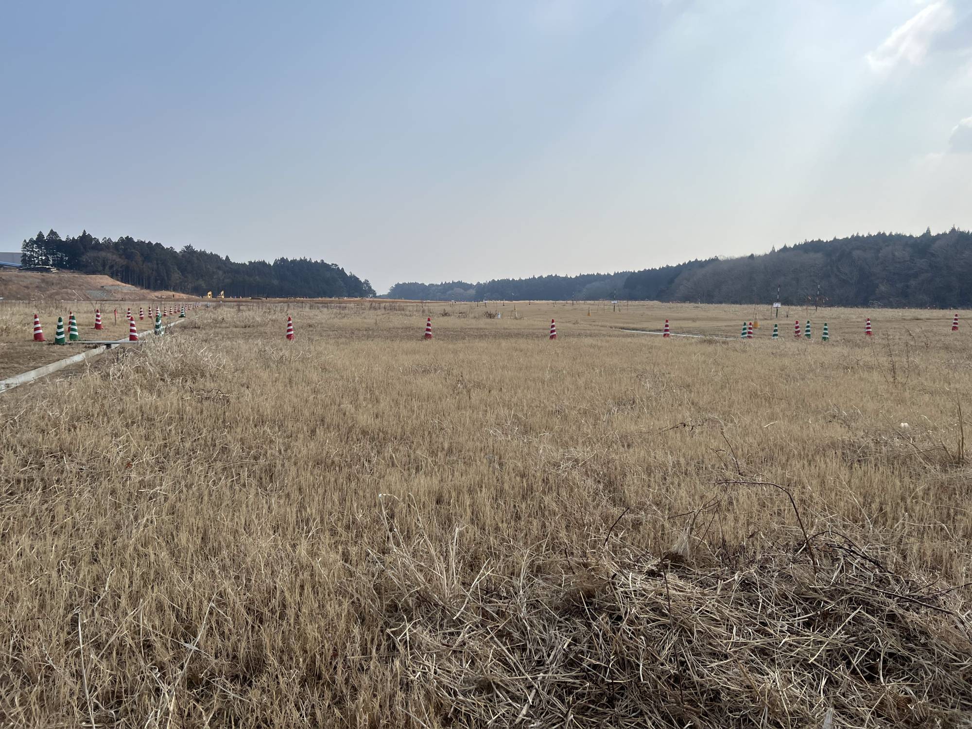 Areas where radioactive soil has been buried look like soccer fields. | TOMOKO OTAKE
