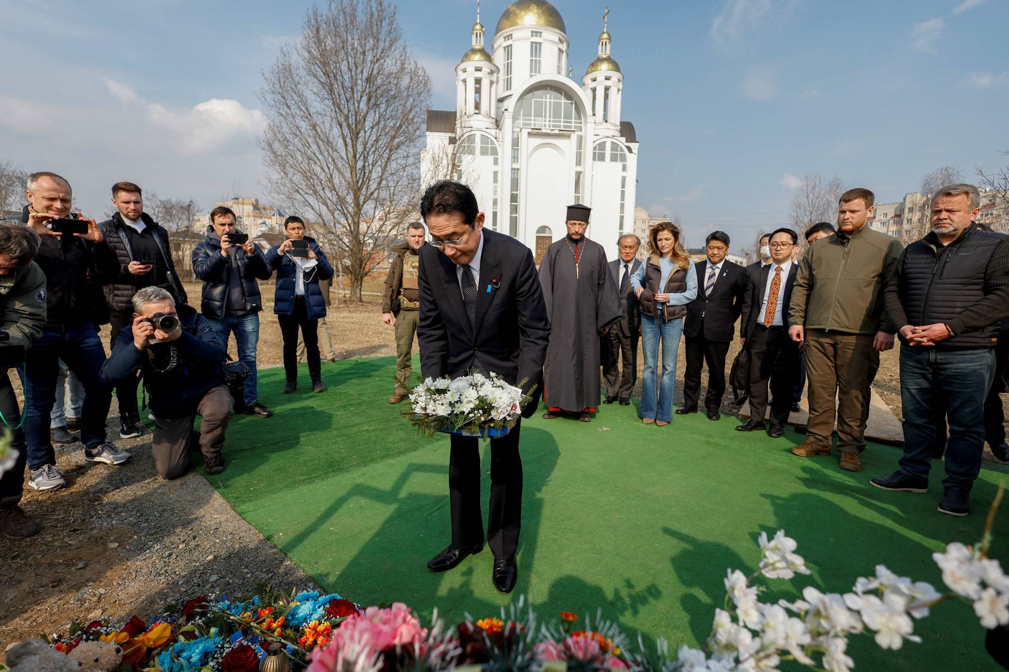 Prime Minister Fumio Kishida visits a site of a mass grave in Bucha, outside Kyiv, on Tuesday. | REUTERS