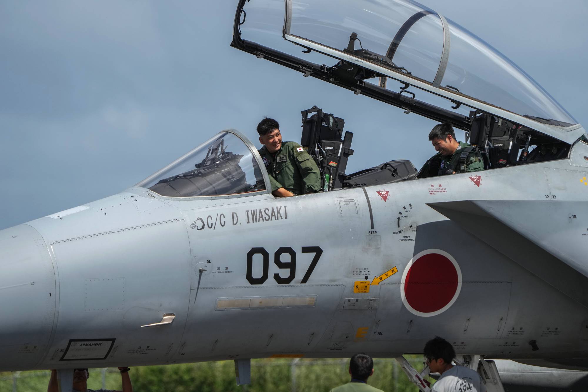 Japanese pilots refuel an F-15 fighter jet at the Tinian airport on Feb. 17. | CHANG W. LEE / THE NEW YORK TIMES