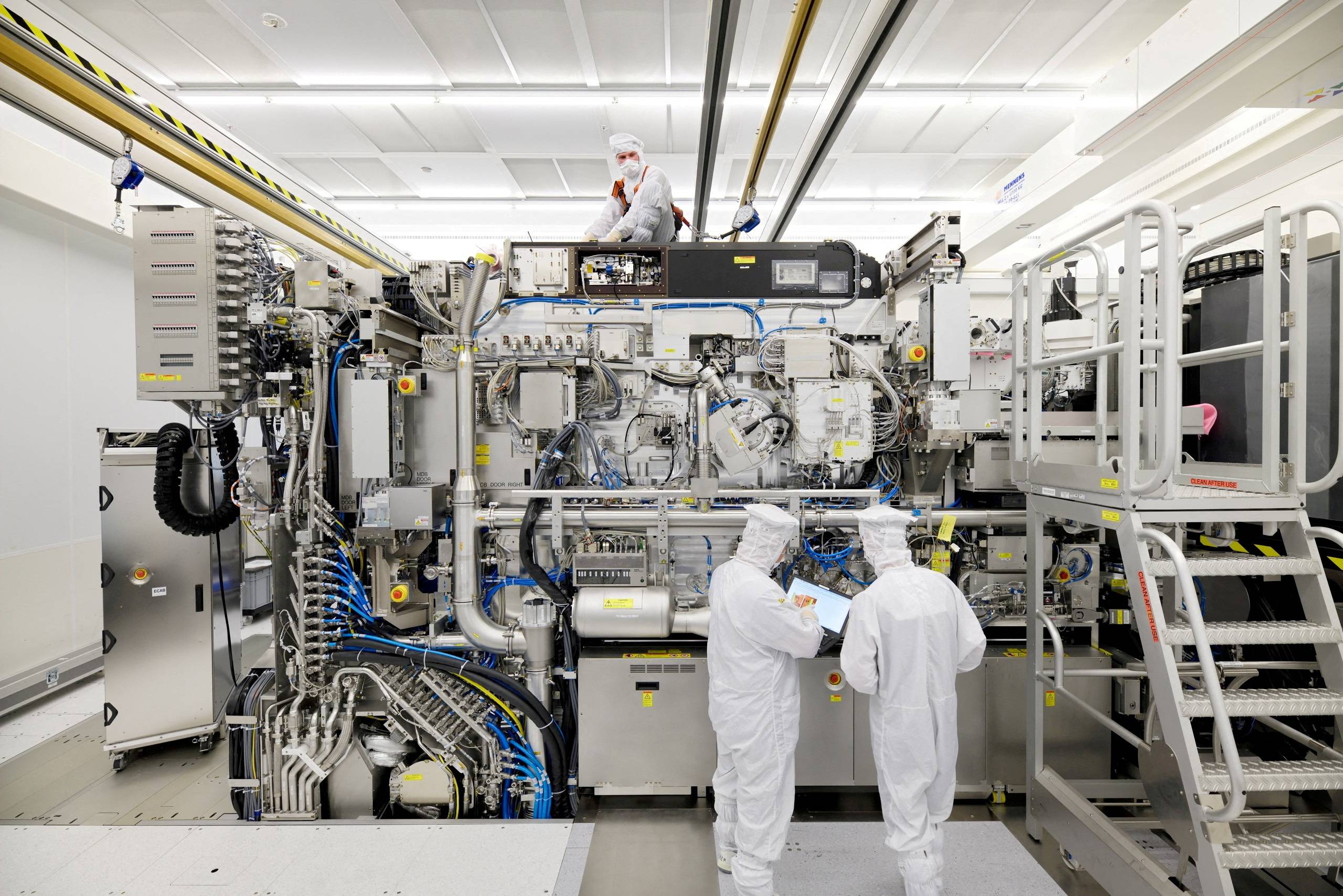 Employees work on the final assembly of ASML's semiconductor lithography tool with its panels removed, in Veldhoven, Netherlands, in April 2019 | ASML / VIA REUTERS Employees work on the final assembly of ASML's semiconductor lithography tool with its panels removed, in Veldhoven, Netherlands, in April 2019 | ASML / VIA REUTERS