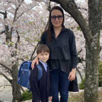 A young Ukrainian war refugee enjoys the cherry blossoms in Hiroshima after starting elementary school in April.