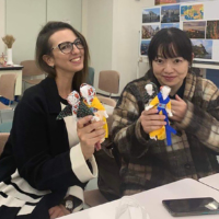 Participants pose with Ukrainian motanka (guardian) dolls they made at a charity event in Hiroshima in December 2022.