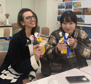 Participants pose with Ukrainian motanka (guardian) dolls they made at a charity event in Hiroshima in December 2022.