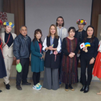 Volunteers pose with Ukrainian refugees in Hiroshima after a charity event in February.