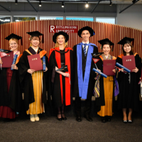 The first graduating class of Ritsumeikan University’s College of Global Liberal Arts  poses for a group photo in March. | RITSUMEIKAN UNIVERSITY