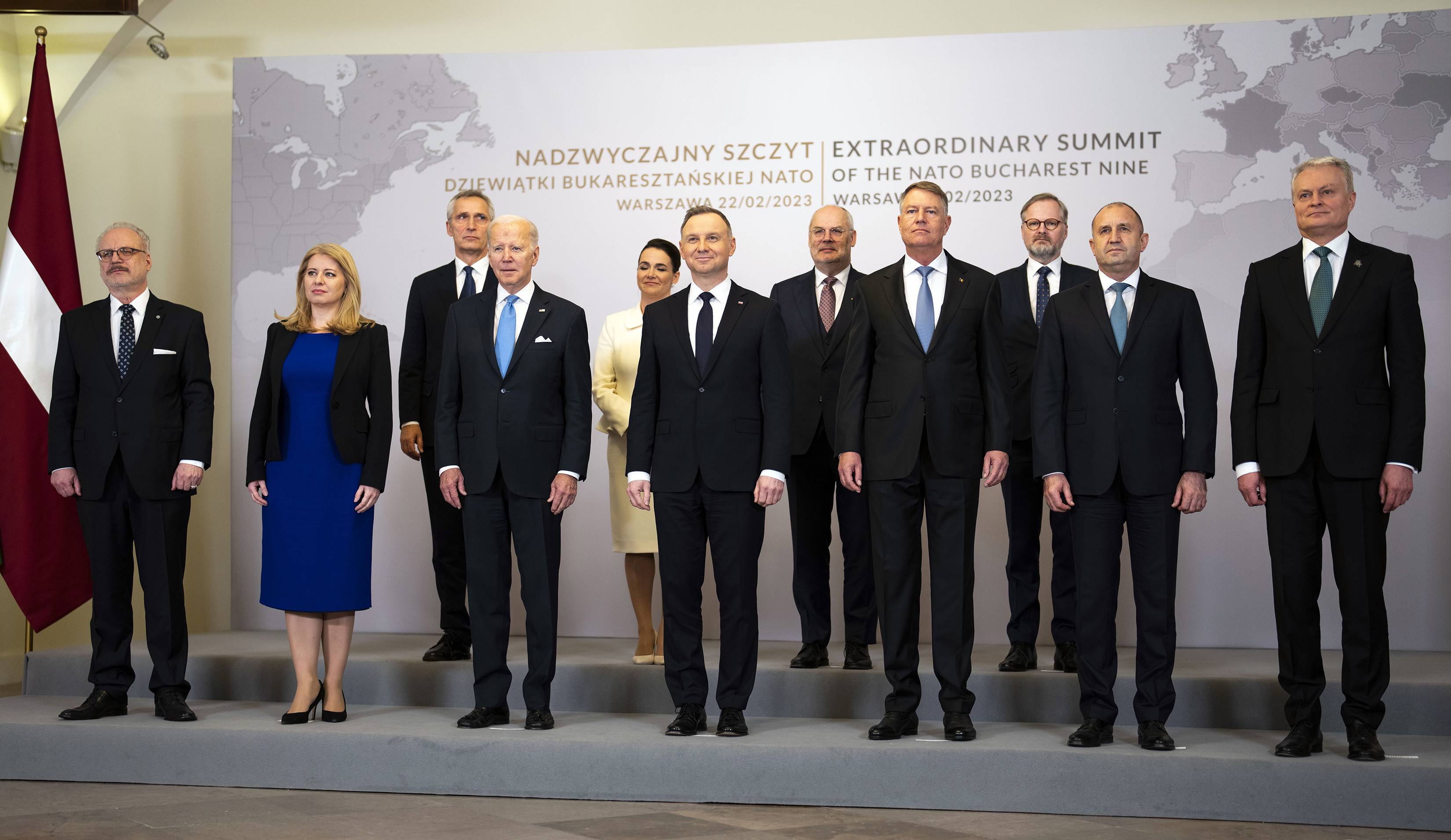 U.S. President Joe Biden, third from left in the front row, poses for a group photograph with leaders from NATO’s eastern flank in Warsaw on Feb. 22. | DOUG MILLS / THE NEW YORK TIMES