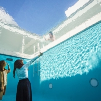 Visitors gaze up from 'The Swimming Pool' by Leandro Erlich at the 21st Century Museum of Contemporary Art, Kanazawa.