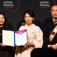 Junko Higuchi (center), manager of Kakurinbo, is recognized at the Japan Travel Awards ceremony on March 7 in Tokyo. | SHIITAKE CREATIVE / JAPAN TRAVEL AWARDS