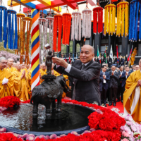 Cambodian King Norodom Sihamoni celebrates Buddha’s birth by pouring sacred water on the statue of newborn Buddha at the Royal Grand Hall of Buddhism at Muryojuji Head Temple in Kato, Hyogo Prefecture, on April 8. | THE BUDDHIST SUMMIT HEADQUARTERS