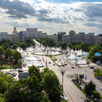 Bucharest, Romania - 9 May 2024: Bucharest aerial photo. Beautiful view of the landmarks of Bucharest from Unirii area (boulevard, fountains and Palace of the Parliament) during a summer day.
