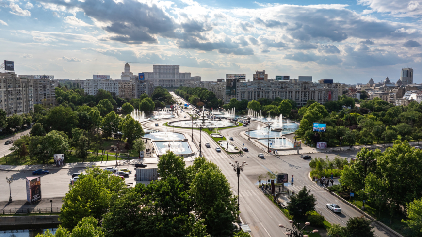 Bucharest, Romania - 9 May 2024: Bucharest aerial photo. Beautiful view of the landmarks of Bucharest from Unirii area (boulevard, fountains and Palace of the Parliament) during a summer day.
