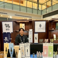 Visitors enjoying sake from Tsunan Town at the festival
