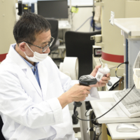 A staffer scans a QR code to input sample information at the Fukushima Agricultural Technology Centre. | RYOICHI SHIMIZU