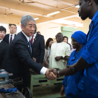 Foreign Minister Takeshi Iwaya speaks with a student at the Senegal-Japan Vocational Training Centre in Dakar on April 29. | AFP-JIJI
