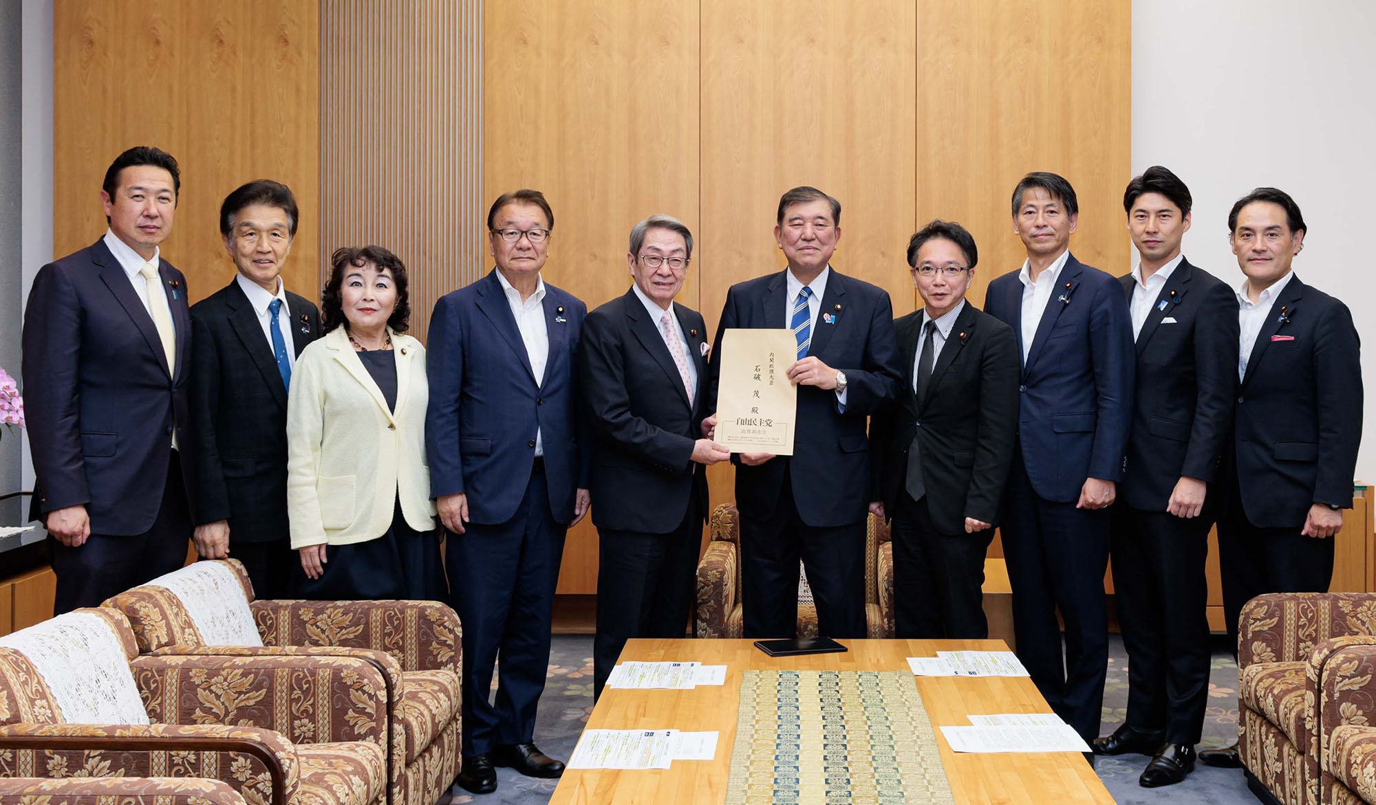 Masatoshi Ishida (fifth from left) and other members of the LDP marine transportation and shipbuilding committee submit their emergency recommendations to then-Prime Minister Shigeru Ishiba (fifth from right) on June 20.